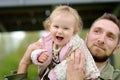 Cute toddler girl having fun on outdoor playground. Young father playing with her little daughter. Spring/summer/autumn active Royalty Free Stock Photo