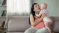 Cute toddler girl kissing and hugging her mother, love and tenderness in family