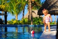 Cute toddler girl playing with ball in swimming Royalty Free Stock Photo