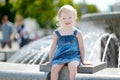 Cute toddler girl playing with a city fountain Royalty Free Stock Photo