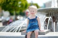 Cute toddler girl playing with a city fountain Royalty Free Stock Photo