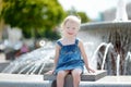 Cute toddler girl playing with a city fountain Royalty Free Stock Photo