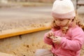 Cute toddler girl playing in sand on outdoor playground. Beautiful baby having fun on sunny warm summer day Royalty Free Stock Photo