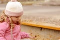 Cute toddler girl playing in sand on outdoor playground. Beautiful baby having fun on sunny warm summer day Royalty Free Stock Photo