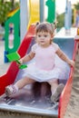 Cute toddler girl playing in sand on outdoor playground. Royalty Free Stock Photo