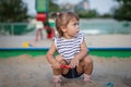 Cute toddler girl playing in sand on outdoor playground. Royalty Free Stock Photo