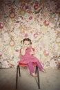 Cute toddler girl sitting on a red chair Royalty Free Stock Photo