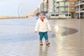 Cute toddler girl walking on winter promenade Royalty Free Stock Photo