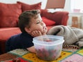 young boy is eating strawberries while watching TV Royalty Free Stock Photo