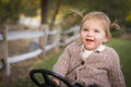Cute Toddler Laughing and Playing on Toy Tractor Outside Royalty Free Stock Photo