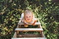 Cute toddler little girl climbs up the ladder, country side, cottagecor Royalty Free Stock Photo