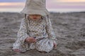 Cute toddler playing with sea shells