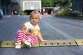 Cute toddler sit on road hump