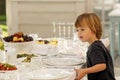 Cute toddler sitting at table served for celebration