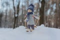 Cute toy girl skiing in the snowy forest Royalty Free Stock Photo