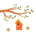 Cute tree branch with green leaves, colorful birdhouse and two yellow-blue birds Royalty Free Stock Photo