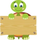 Cute turtle holding a wooden signboard Royalty Free Stock Photo