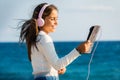 Cute tween girl listening music with headphones and tablet outdoors Royalty Free Stock Photo