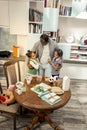 African-American father wearing jeans hugging his cute twins Royalty Free Stock Photo