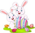 Cute two little bunnies with Easter egg in the grass Royalty Free Stock Photo