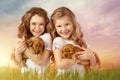 Cute two little girls with red puppies outdoor. Kids pet friendship Royalty Free Stock Photo