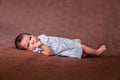 Cute two weeks old newborn baby girl lying down