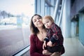 Cute two year old boy on mother`s hands during walk in public place Royalty Free Stock Photo