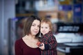 Cute two year old boy on mother`s hands during walk in public place Royalty Free Stock Photo