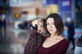 Cute two year old boy on mother`s hands during walk in public place Royalty Free Stock Photo