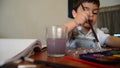 Cute two years old boy painting with water colours