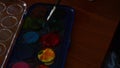 Cute two years old boy painting with water colours