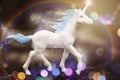 Cute unicorn walking in the sparkling rainbow forest