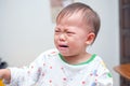 Cute upset stress sad unhappy little Asian toddler baby boy child crying, Toddler having tantrum at home Royalty Free Stock Photo