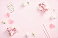 Cute Valentines day composition. Flat lay gift boxes with ribbon bow, greeting card, paper hearts, roses flowers on pastel pink Royalty Free Stock Photo