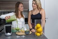 Vegan lesbian couple, preparing spinach smoothie. LGTB concept, vegan people