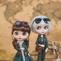 Cute Vintage dolls. Cute innocent dolls in navigation and travelling concept with blur aeroplane and world map on the background
