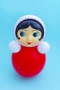 A cute vintage red tumbler toy in the shape of a round girl