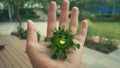 Cute virus on a hand 3D render