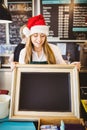 Cute waitress holding a blackboard