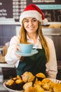 Cute waitress standing behind the counter