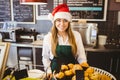 Cute waitress standing behind the counter