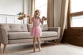 Kid girl listen song feels excited dancing in living room Royalty Free Stock Photo