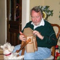 Westie dog helping Man unwrap briefcase for Christmas