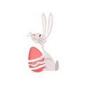 Cute White Easter Bunny Sitting with Red Egg, Funny Rabbit Cartoon Character Vector Illustration Royalty Free Stock Photo