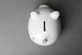 Cute white piggy bank on gray background Royalty Free Stock Photo