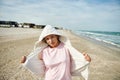 Cute woman on the beach enjoying beautiful nature in the beautiful seaside. Love nature and planet earth protection concept Royalty Free Stock Photo