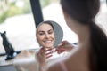 Cute woman in pink lingerie looking in the mirror and smiling Royalty Free Stock Photo