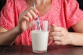 Cute woman drinking milk in her kitchen Royalty Free Stock Photo