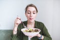 Cute woman eats a plate salad. Correct and delicious food. Healthy food. Enjoy the useful food Royalty Free Stock Photo