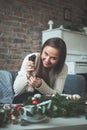 Cute Woman with Electric Glue Gun and Christmas Decor